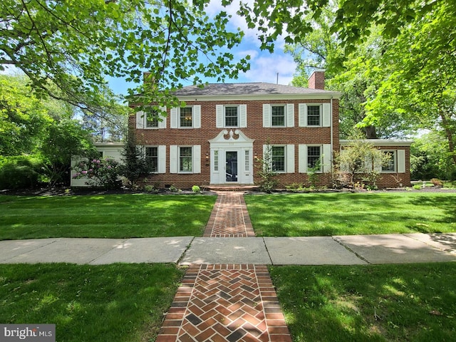 505 Hillcrest Ave, State College, PA 16803 - colonial house featuring a front yard, brick siding, and a chimney