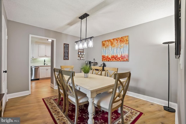 5904 Mount Eagle Dr Unit 1003, Alexandria, VA 22303 - dining space with light wood finished floors, a textured ceiling, and baseboards