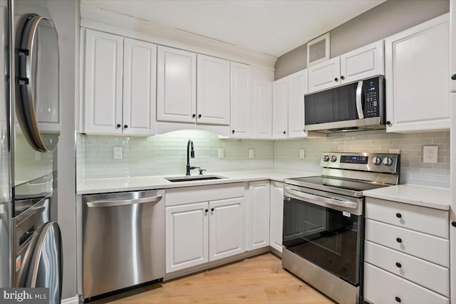 5904 Mount Eagle Dr Unit 1003, Alexandria, VA 22303 - kitchen featuring appliances with stainless steel finishes, a sink, white cabinetry, and light countertops