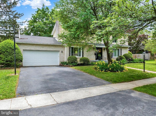 89 Wellington Blvd, Wyomissing, PA 19610 - view of property hidden behind natural elements with driveway, a front lawn, and a garage