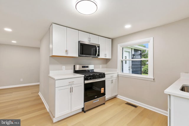 1106 Fiji Ave, Landover, MD 20785 - kitchen with appliances with stainless steel finishes, light wood-style flooring, baseboards, light countertops, and recessed lighting