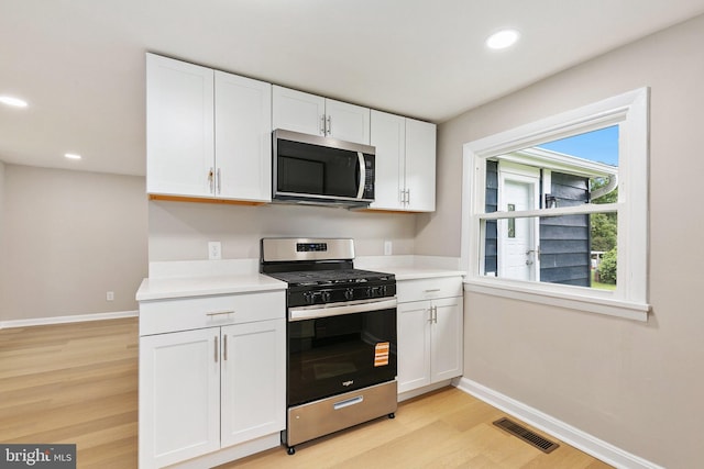 1106 Fiji Ave, Landover, MD 20785 - kitchen featuring stainless steel appliances, baseboards, light wood-type flooring, white cabinetry, and recessed lighting