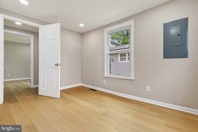 1106 Fiji Ave, Landover, MD 20785 - empty room with electric panel, light wood finished floors, baseboards, and recessed lighting