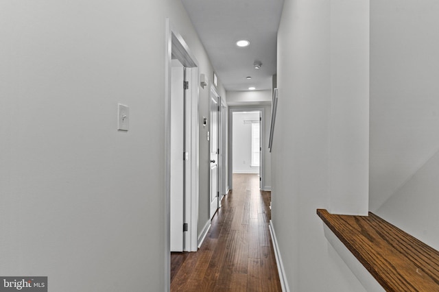 corridor with baseboards, dark wood-type flooring, and recessed lighting