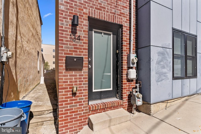 entrance to property with brick siding and board and batten siding