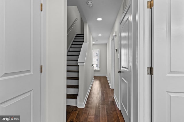 corridor with dark wood-style flooring, recessed lighting, baseboards, and stairs