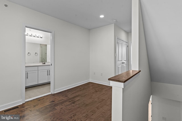 interior space with dark wood-style floors, baseboards, and recessed lighting