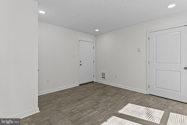 empty room with baseboards and recessed lighting