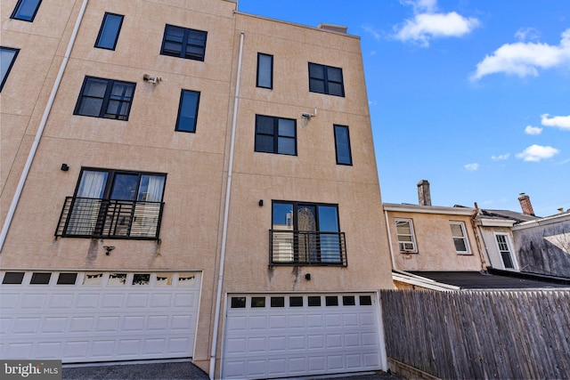 view of front of house featuring an attached garage and stucco siding