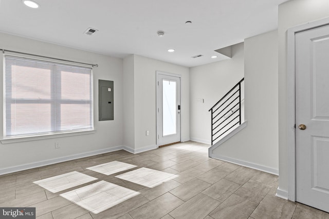 foyer entrance with electric panel, healthy amount of natural light, stairs, recessed lighting, and baseboards