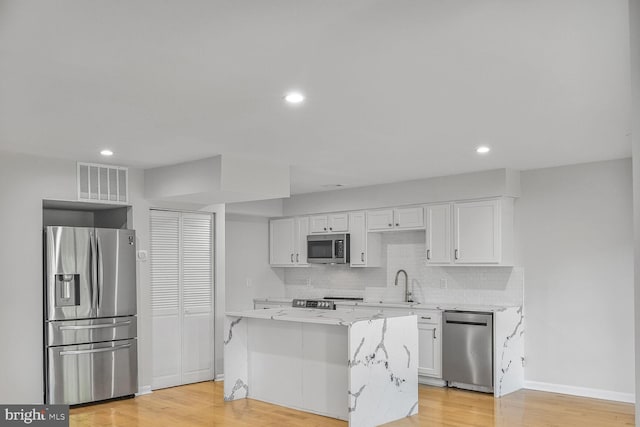 8118 Chapel Cove Dr, Laurel, MD 20707 - kitchen with appliances with stainless steel finishes, a sink, white cabinets, decorative backsplash, and recessed lighting