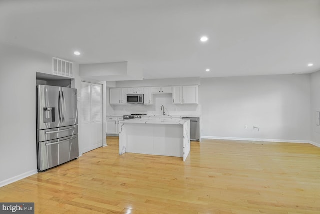 8118 Chapel Cove Dr, Laurel, MD 20707 - kitchen featuring stainless steel appliances, a sink, baseboards, white cabinetry, and recessed lighting