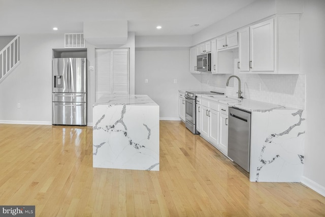 8118 Chapel Cove Dr, Laurel, MD 20707 - kitchen with stainless steel appliances, white cabinets, a sink, light wood finished floors, and recessed lighting