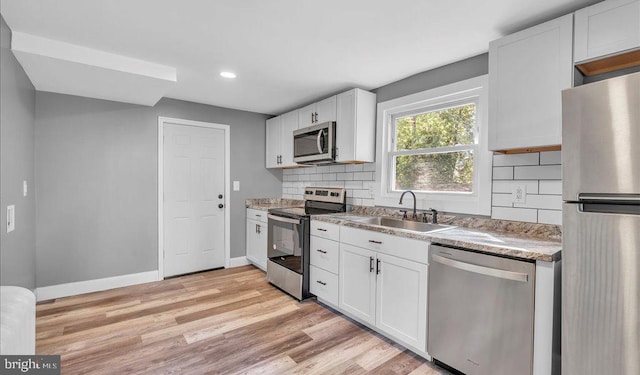 212 Broad St, Elmer, NJ 08318 - kitchen featuring stainless steel appliances, a sink, tasteful backsplash, light wood-style flooring, and baseboards
