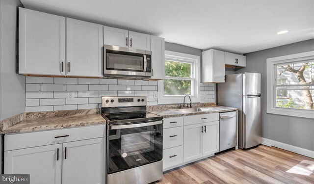 212 Broad St, Elmer, NJ 08318 - kitchen with appliances with stainless steel finishes, a sink, tasteful backsplash, white cabinets, and recessed lighting