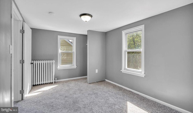 212 Broad St, Elmer, NJ 08318 - carpeted empty room with radiator heating unit, baseboards, and a smoke detector