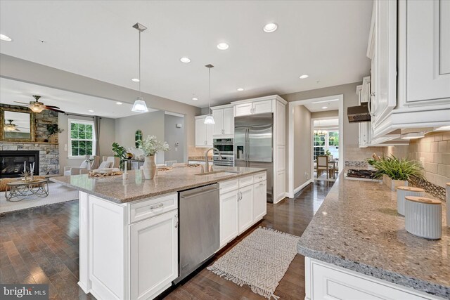 9830 Forge Valley Ct, Perry Hall, MD 21128 - kitchen featuring appliances with stainless steel finishes, a sink, decorative backsplash, a fireplace, and recessed lighting