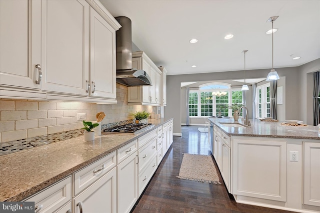 9830 Forge Valley Ct, Perry Hall, MD 21128 - kitchen with stainless steel gas stovetop, wall chimney exhaust hood, a sink, decorative backsplash, and a kitchen island with sink