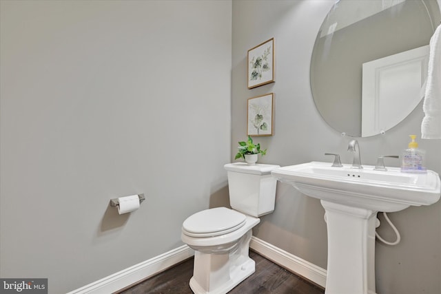 9830 Forge Valley Ct, Perry Hall, MD 21128 - half bathroom with toilet, baseboards, and wood finished floors