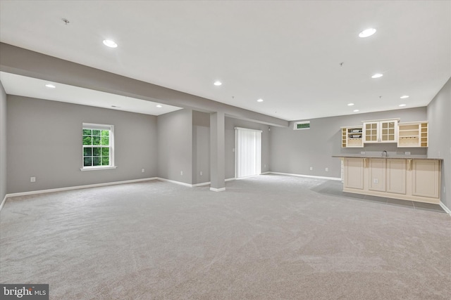 9830 Forge Valley Ct, Perry Hall, MD 21128 - unfurnished living room with bar with sink, light colored carpet, baseboards, and recessed lighting