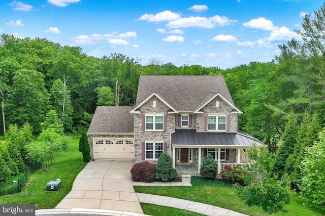 9830 Forge Valley Ct, Perry Hall, MD 21128 - view of front of home featuring stone siding, covered porch, an attached garage, and a front yard