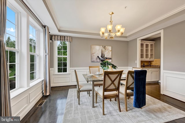 9830 Forge Valley Ct, Perry Hall, MD 21128 - dining room featuring dark wood finished floors, a decorative wall, a chandelier, a wainscoted wall, and crown molding