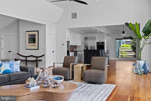 2514 Lyon Dr, Annapolis, MD 21403 - living area featuring a ceiling fan, light wood-style flooring, baseboards, and high vaulted ceiling