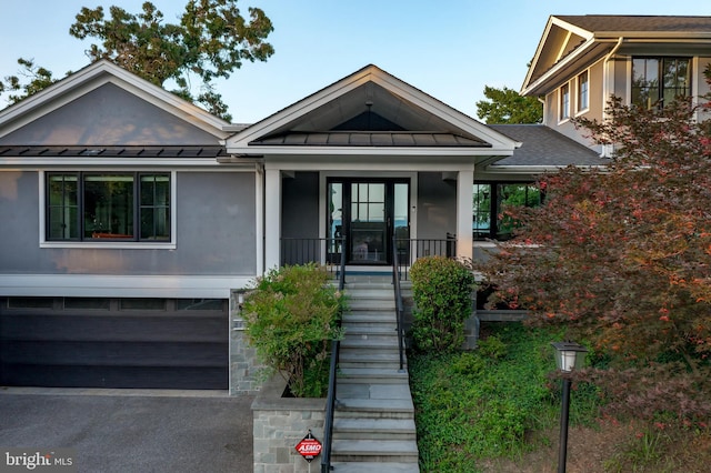 2514 Lyon Dr, Annapolis, MD 21403 - view of front of property with a standing seam roof, metal roof, a garage, stairs, and covered porch