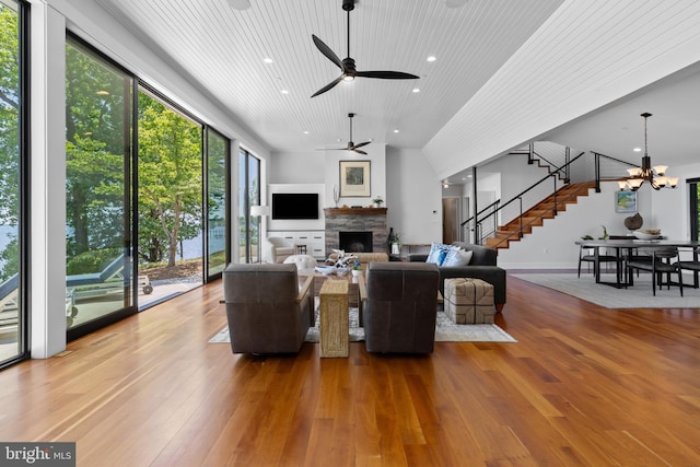 2514 Lyon Dr, Annapolis, MD 21403 - living room featuring stairway, a stone fireplace, wood-type flooring, wooden ceiling, and a ceiling fan