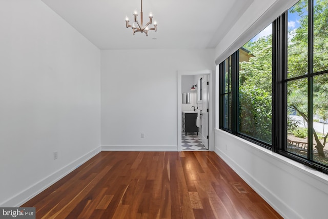 2514 Lyon Dr, Annapolis, MD 21403 - unfurnished room featuring a chandelier, wood finished floors, and baseboards