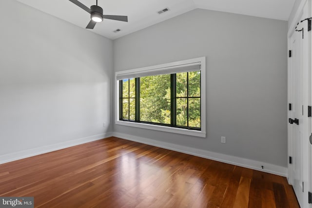 2514 Lyon Dr, Annapolis, MD 21403 - spare room with wood finished floors, a ceiling fan, vaulted ceiling, baseboards, and a barn door