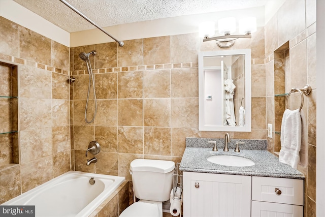 958 Tympani, Herndon, VA 20170 - full bathroom with a textured ceiling, tile walls, tiled shower / bath combo, vanity, and toilet