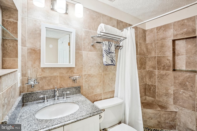 958 Tympani, Herndon, VA 20170 - full bathroom with a textured ceiling, tiled shower, toilet, tile walls, and vanity