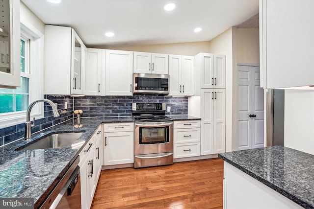 958 Tympani, Herndon, VA 20170 - kitchen with stainless steel appliances, a sink, light wood-style flooring, white cabinets, and dark stone countertops