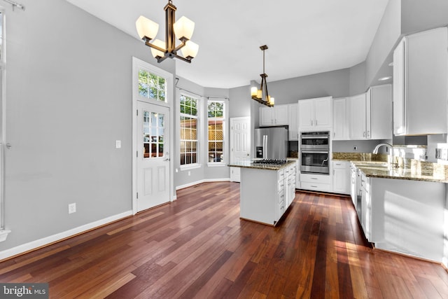 20580 Willoughby Sq, Sterling, VA 20165 - kitchen featuring a chandelier, appliances with stainless steel finishes, dark wood finished floors, a center island, and white cabinets