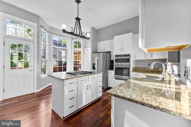 20580 Willoughby Sq, Sterling, VA 20165 - kitchen featuring a sink, appliances with stainless steel finishes, dark wood-style flooring, and light stone countertops