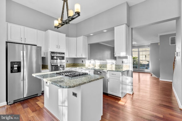 20580 Willoughby Sq, Sterling, VA 20165 - kitchen with appliances with stainless steel finishes, white cabinets, dark wood finished floors, light stone countertops, and crown molding