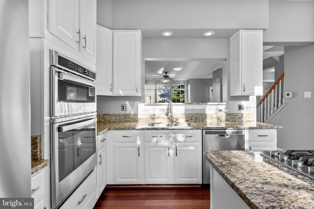20580 Willoughby Sq, Sterling, VA 20165 - kitchen featuring a sink, stainless steel appliances, ceiling fan, dark wood-style flooring, and white cabinets