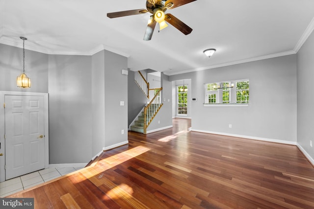 20580 Willoughby Sq, Sterling, VA 20165 - spare room with ornamental molding, wood finished floors, stairs, baseboards, and a ceiling fan