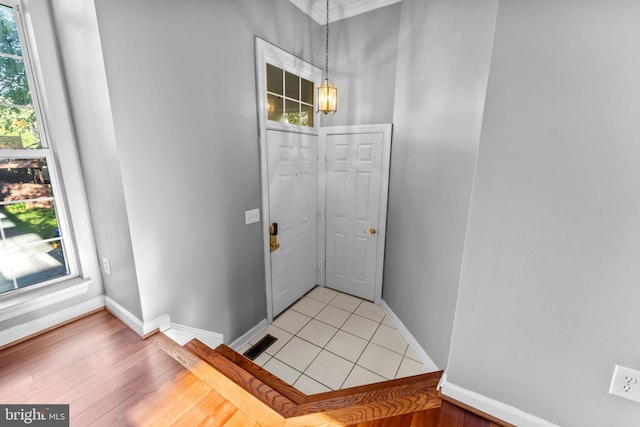 20580 Willoughby Sq, Sterling, VA 20165 - foyer entrance with baseboards, ornamental molding, and light wood-style flooring