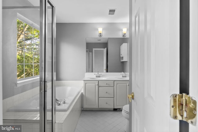 20580 Willoughby Sq, Sterling, VA 20165 - full bathroom featuring double vanity, a garden tub, tile patterned floors, and a shower stall