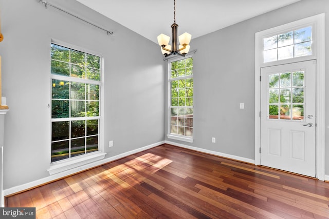20580 Willoughby Sq, Sterling, VA 20165 - unfurnished dining area with a chandelier, healthy amount of natural light, and hardwood / wood-style flooring