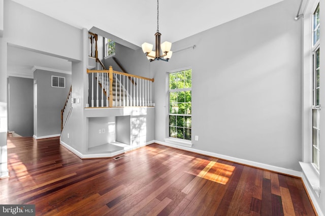 20580 Willoughby Sq, Sterling, VA 20165 - unfurnished living room featuring stairs, wood-type flooring, a chandelier, and baseboards