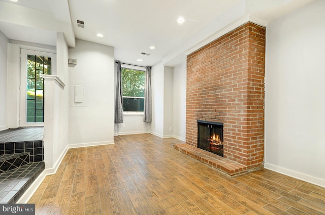 1726 U St NW Unit 1, Washington, DC 20009 - unfurnished living room with wood finished floors, healthy amount of natural light, a fireplace, and recessed lighting