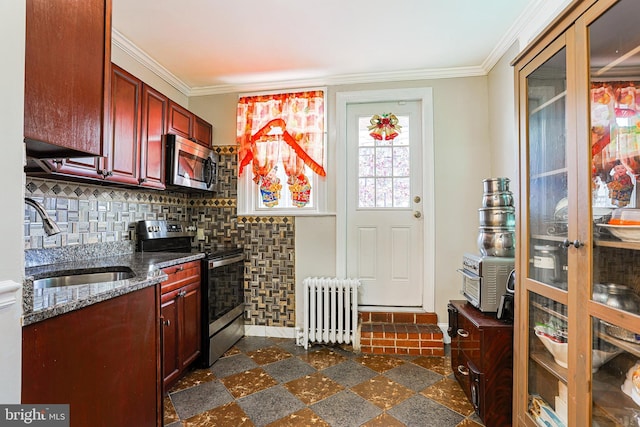 4719 Rorer St, Philadelphia, PA 19120 - kitchen with radiator heating unit, stainless steel appliances, a sink, dark brown cabinets, and ornamental molding