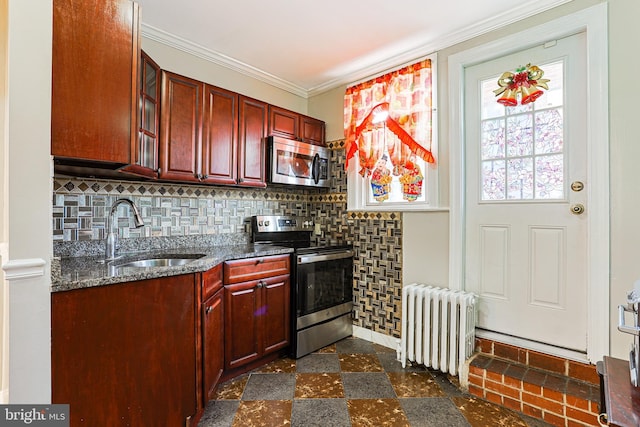 4719 Rorer St, Philadelphia, PA 19120 - kitchen featuring stainless steel appliances, a sink, radiator, reddish brown cabinets, and crown molding