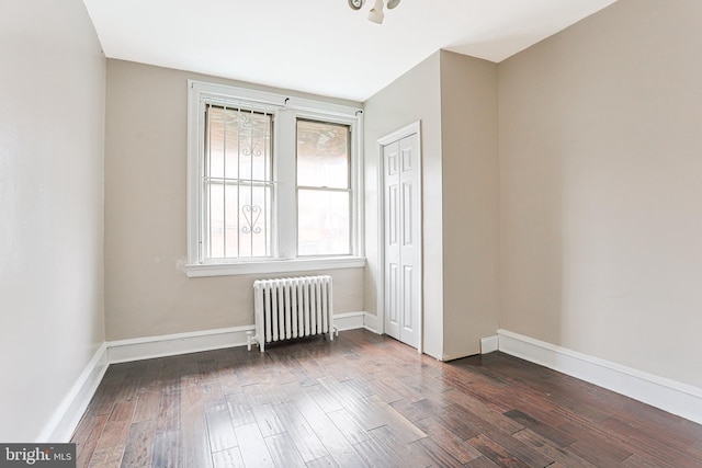 4719 Rorer St, Philadelphia, PA 19120 - spare room featuring radiator, dark wood-style flooring, and baseboards