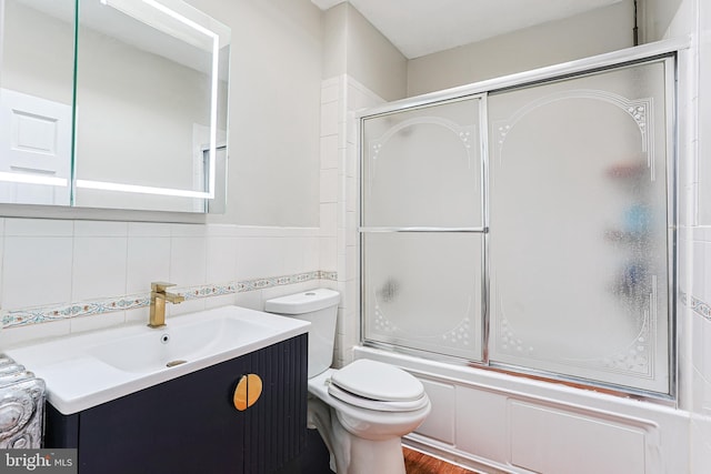 4719 Rorer St, Philadelphia, PA 19120 - bathroom featuring vanity, toilet, bath / shower combo with glass door, wood finished floors, and tile walls