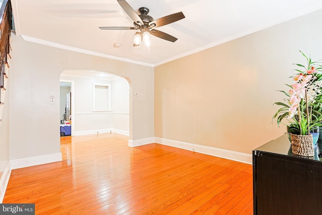 4719 Rorer St, Philadelphia, PA 19120 - unfurnished room with arched walkways, a ceiling fan, light wood-type flooring, ornamental molding, and stairs