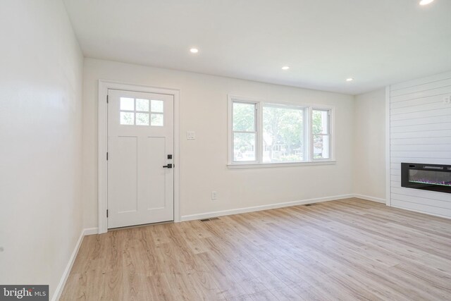 110 3rd St, Brooklawn, NJ 08030 - foyer entrance featuring light wood finished floors, healthy amount of natural light, a large fireplace, baseboards, and recessed lighting